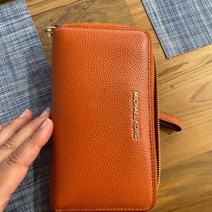 Micheal Kors orange wristlet.